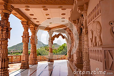 artistic hand carved red stone jain temple at morning from unique angle Stock Photo