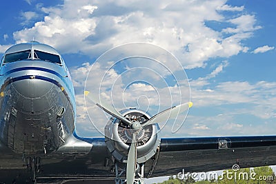 WWII Warbird headon with engine and wing in blue sky with clouds Stock Photo