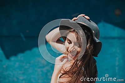 Artistic photo of young hipster traveler girl with hat at the sea Stock Photo