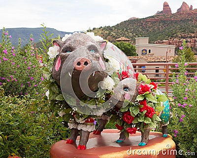 Artistic pigs decked with flowers in front of a store in sedona Editorial Stock Photo