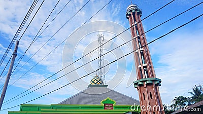 Harmony of Tradition and Technology: An Artistic View of a Mosque with Electrical Wires Stock Photo