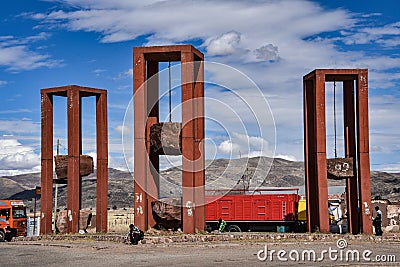 Artistic sculpture of three massive hanging rock blocks, at the entrance to Tiwanaku archaeological site, near La Paz, Bolivia Editorial Stock Photo