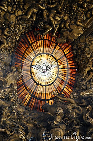 Artistic stained glass window of the Holy Spirit depicted with a dove inside the basilica of San Pietro in Rome Editorial Stock Photo