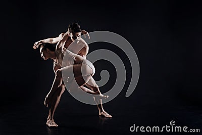 Artistic young gymnasts performing in the studio Stock Photo