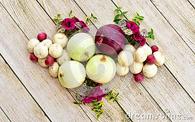 Artistically arranged flowers and vegetables for displaying healthy organic foods Stock Photo