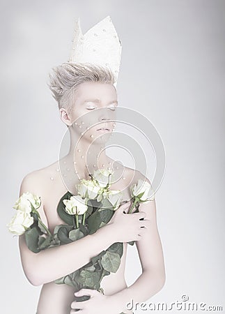 Artistry. Trendy Young Man in Paper Crown with Flowers Stock Photo