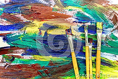 Artists oil paints multicolored abstract texture with brushes top view Stock Photo