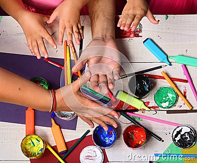 Artists open palms with stationery and colored paper Stock Photo