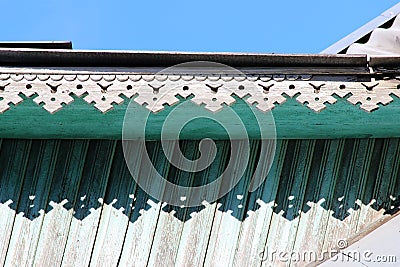 artsy decor trim and classic old wooden house. triangular patterns wood texture turquoise color. Stock Photo