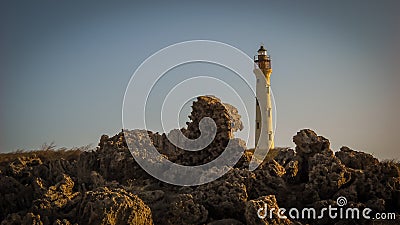 Aruba Image with California Lighthouse and Rocks in foreground Stock Photo