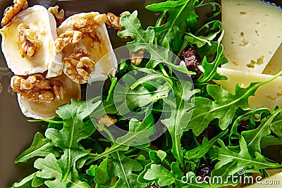 Arugula salad with goat cheese honey and nuts Stock Photo