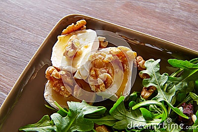 Arugula salad with goat cheese honey and nuts Stock Photo
