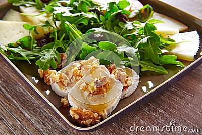 Arugula salad with goat cheese honey and nuts Stock Photo