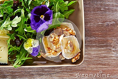 Arugula salad with goat cheese honey and nuts Stock Photo