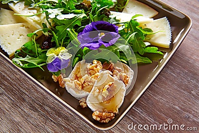 Arugula salad with goat cheese honey and nuts Stock Photo