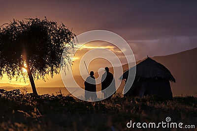 Arusha, Tanzania on 1st June 2019. Family with masai walking at sunrise at there house Editorial Stock Photo