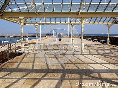 Tourists Walking Along Dun Laoghaire Pier in Ireland Editorial Stock Photo