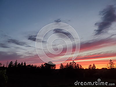 Rainbow Skies and Silhouettes Stock Photo