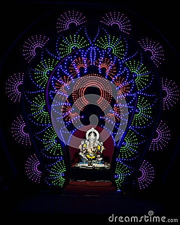 Close up , portrait view of lighting and decorated and garlanded Isolated idol of Hindu God Ganesha in Pune ,Maharashtra, India. Stock Photo