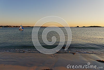 Sailing at sunset off the beach in Landeda, Brittany Stock Photo