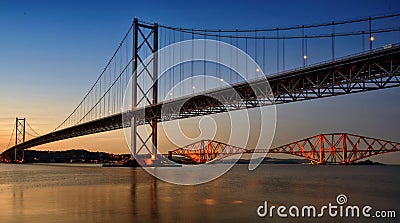 Forth Road Bridge with the Forth Bridge in the background at dusk. Stock Photo