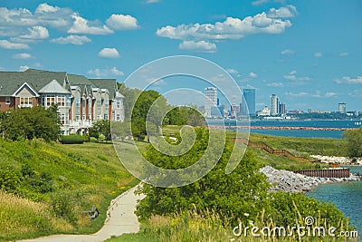 a recreational trail passes between condos and Lake Michigan in Milwaukee, WI Editorial Stock Photo