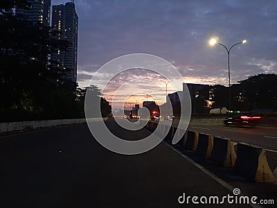 As you begin your daily routine, the light of dawn that light the buildings and streets greets you. Stock Photo