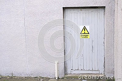 Asbestos Danger Sign on Door at Construction Site of Old Building Stock Photo