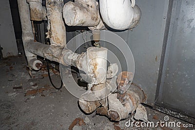 Asbestos pipe insulation in a mechanical room Stock Photo