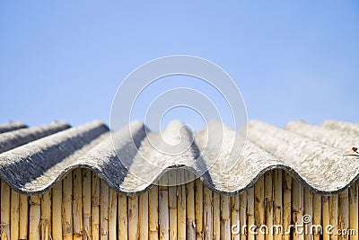 Asbestos roof above a wattle wall - image with copy space Stock Photo