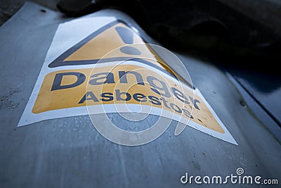 Asbestos warning sign on building Stock Photo