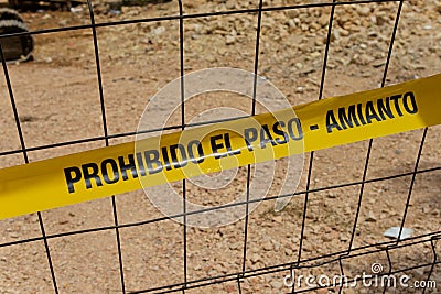 Asbestos warning tape with the text in Spanish: Stock Photo