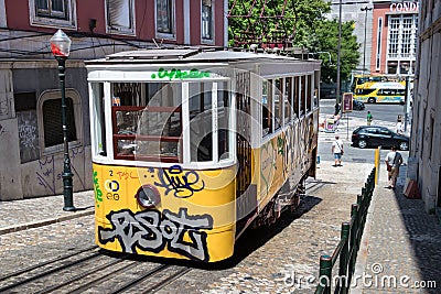 The Ascensor Da Gloria, funicular yellow tram on a stone paviment in Lisbon, Portugal Editorial Stock Photo