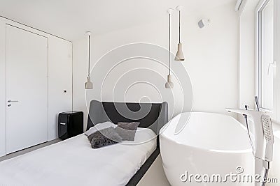 Ascetic bedroom with oval bathtub Stock Photo