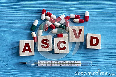 ASCVD - acronym on wooden cubes on a blue background with tablets and thermometer Stock Photo