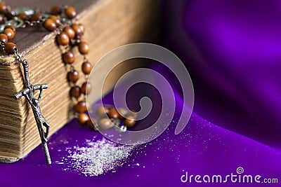 Ash Wednesday religion concept on violet fabric background with rosary Stock Photo