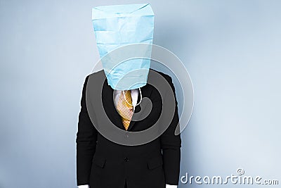 Ashamed businessman with bag over his head Stock Photo