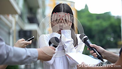 Ashamed businesswoman closing face with hands on press conference, scandal Stock Photo