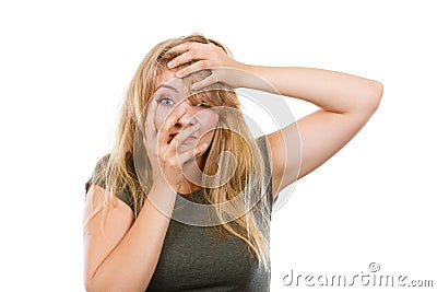 Ashamed embarrassed blonde woman with hand on face Stock Photo