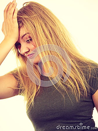 Ashamed embarrassed blonde woman with hand on face Stock Photo