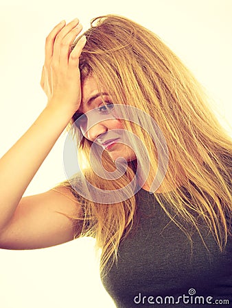 Ashamed embarrassed blonde woman with hand on face Stock Photo