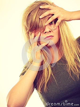 Ashamed embarrassed blonde woman with hands on face Stock Photo