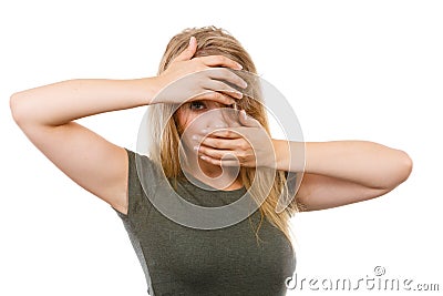 Ashamed embarrassed blonde woman with hands on face Stock Photo