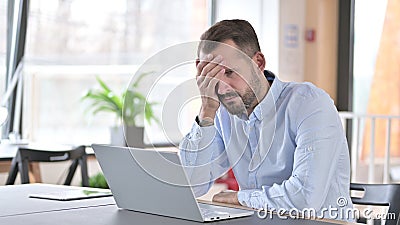 Ashamed Young Man Sitting Disappointed at Work, Loss Stock Photo