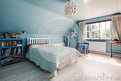 Blue decorated bedroom with sloping ceiling Editorial Stock Photo