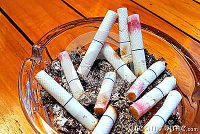 Ashtray and butted out cigarettes with lipstick Stock Photo