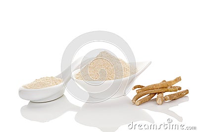 Ashwagandha powder in spoon with roots Stock Photo