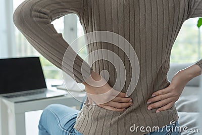 Asia beautiful woman holding her lower back while and suffer from unbearable pain health and problems, chronic back pain, backache Stock Photo