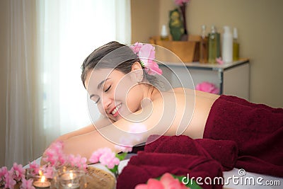 Asia beauty woman lying down on massage bed with scrub sugar and salt aroma at Thai spa and wellness center, Stock Photo