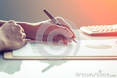 Asia business woman analyzing investment charts on desk. Stock Photo